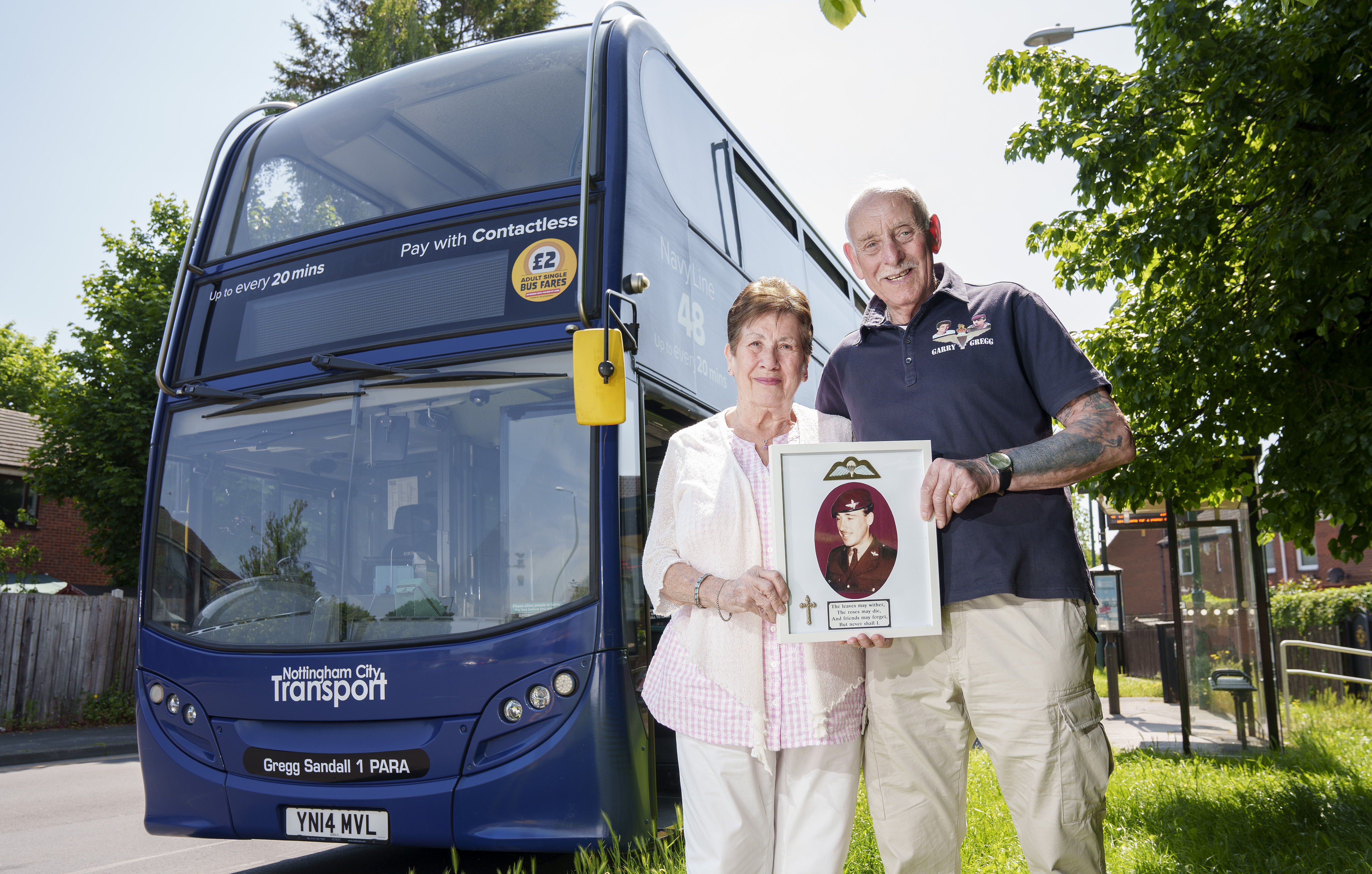 The bus named Gregg Sandall with his parents Sandy and Marina in front of the bus